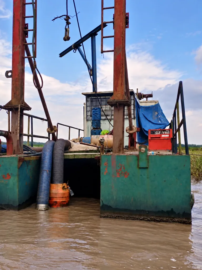 AI-enhanced company-supplied photo: Floating green dredging pontoon with twin lifting gantries and discharge hoses