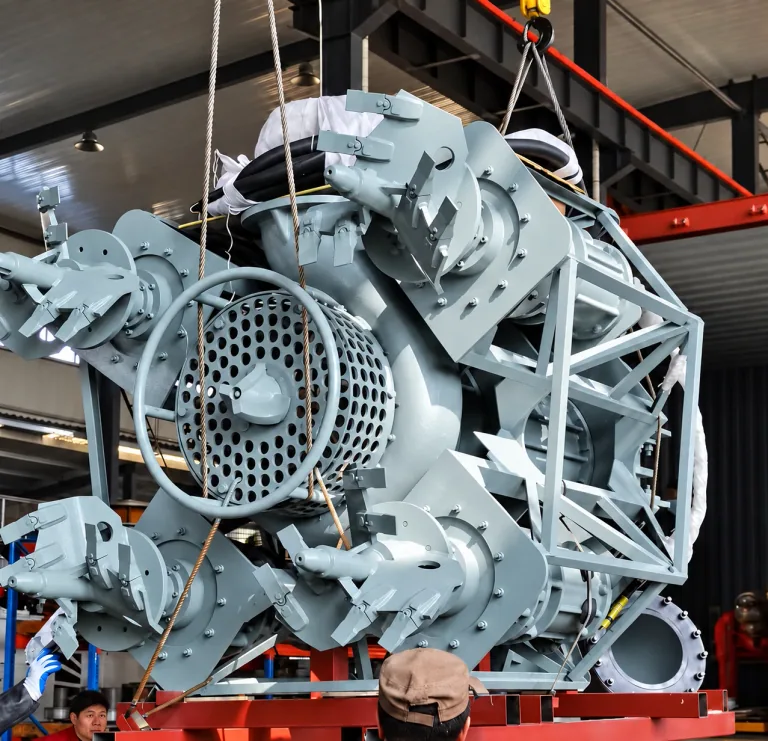 AI-enhanced manufacturer reference: Angled view of the grey submersible pump assembly, intake screen, surrounding agitators and lifting cables
