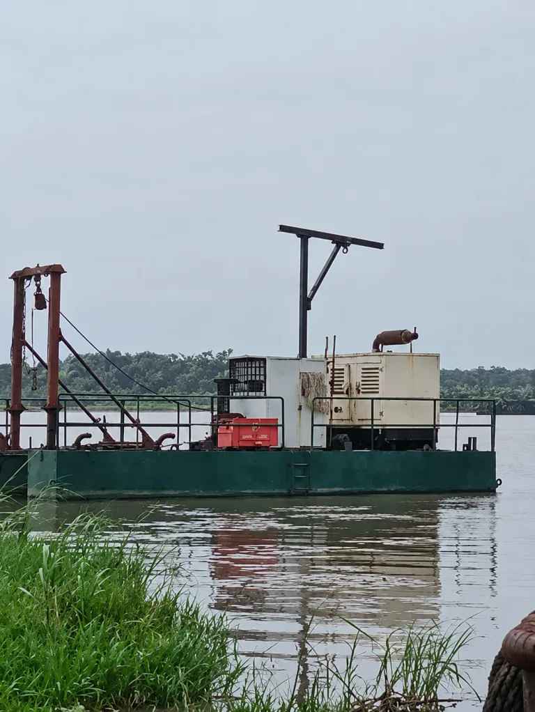AI-enhanced green dredger barge and generator on a lagoon